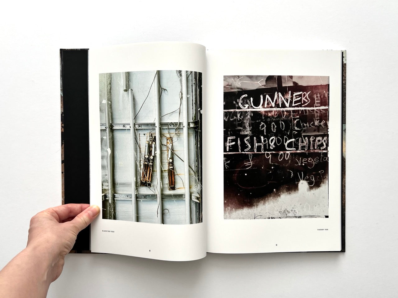 Interior spread from Dubious Splendor: Graphic Works by Rob Sanders 2023–2024 showing industrial photographic textures and street signage fragment