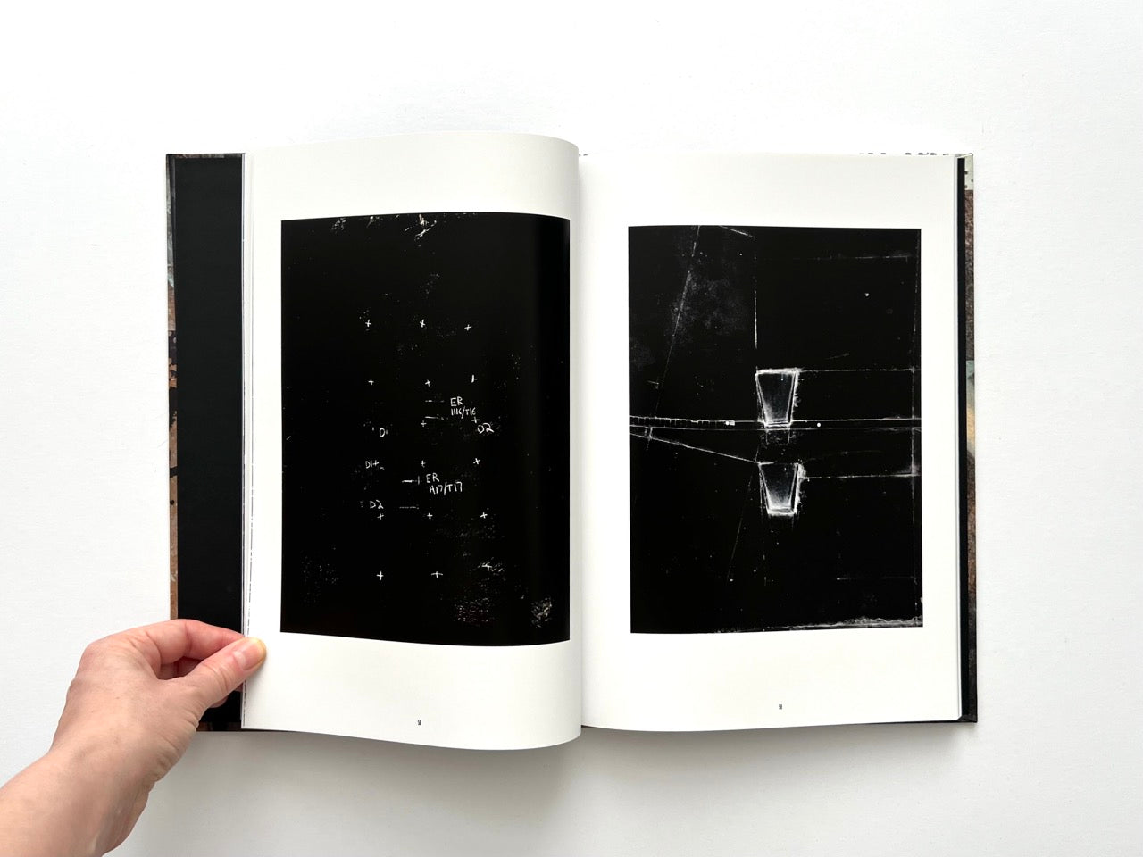 Interior spread from Dubious Splendor: Graphic Works by Rob Sanders 2023–2024 with high-contrast black compositions and minimal mark-making