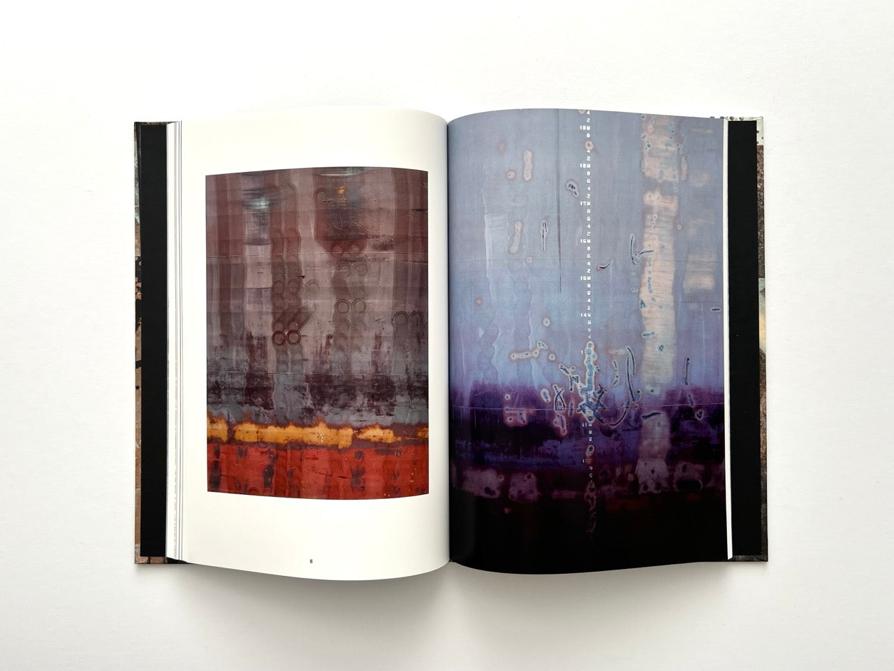 Interior spread from Dubious Splendor: Graphic Works by Rob Sanders 2023–2024 showing layered photographic abstractions in purple and red tones