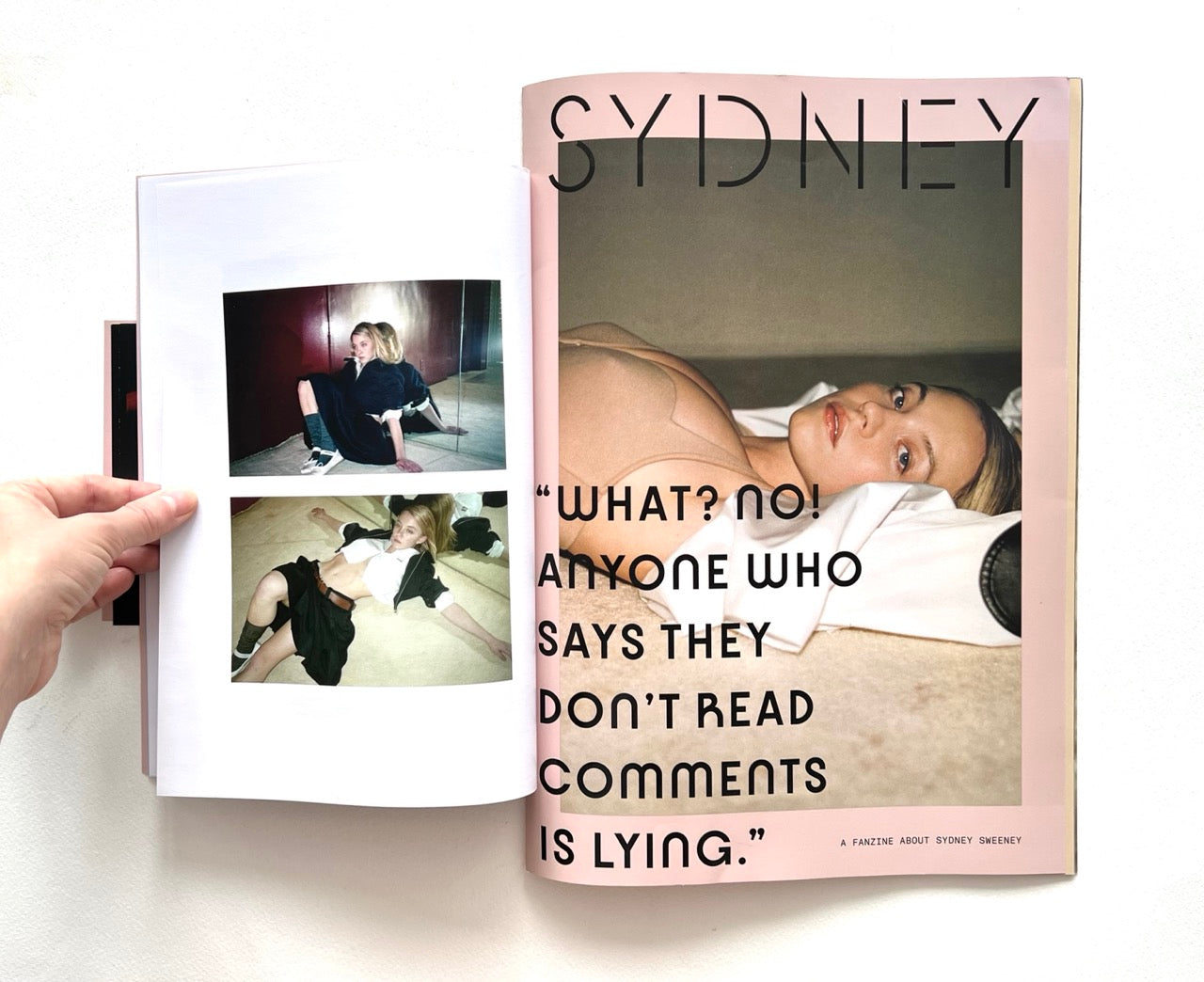 Magazine open to a page with Sydney Sweeney lying down and text, "What? No! Anyone who says they don't read comments is lying."