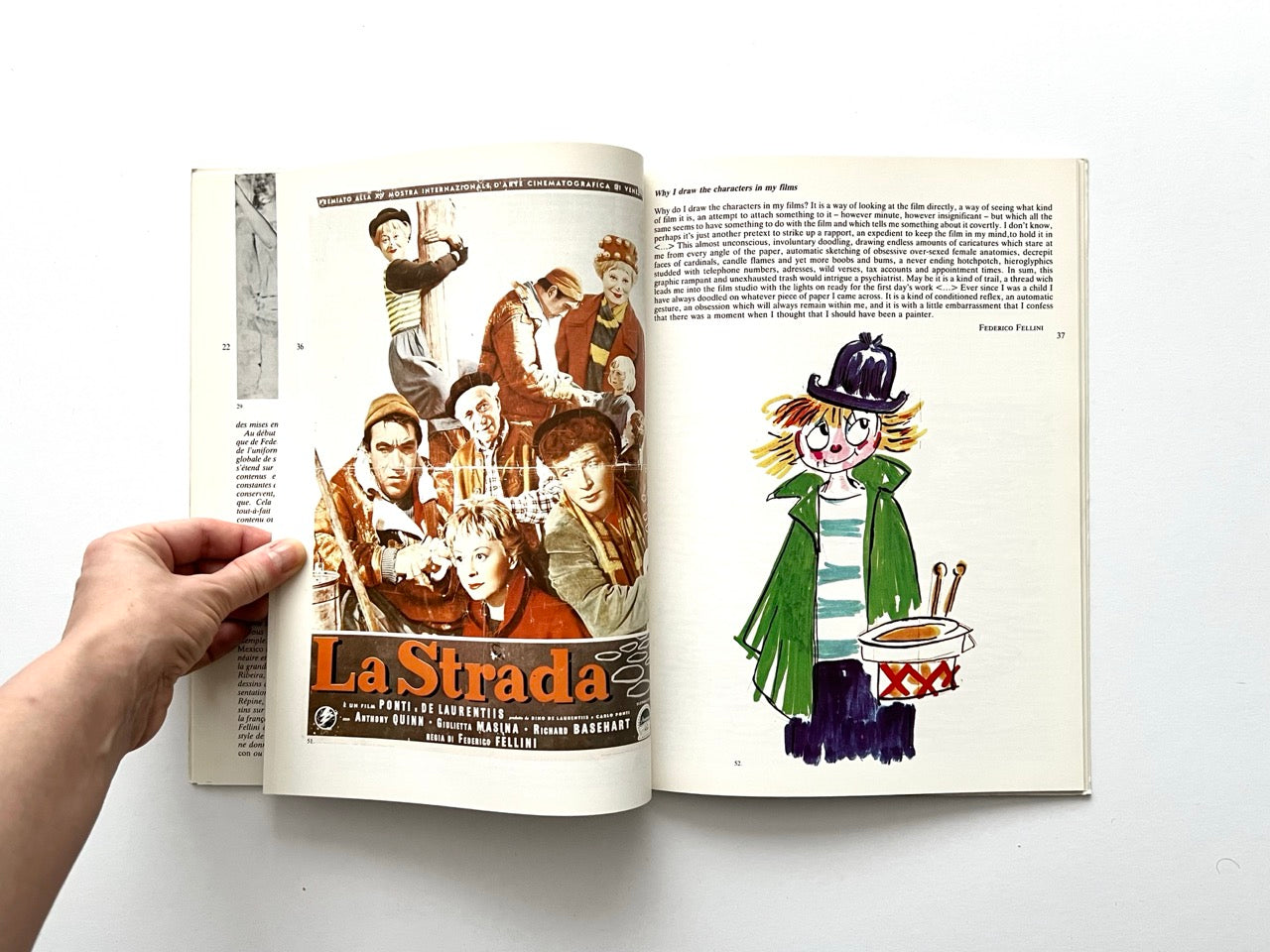 Interior spread with a full-colour film poster for La Strada on the left page, featuring Giulietta Masina, Anthony Quinn and Richard Basehart. Right page shows a coloured drawing of a young character in a striped shirt and green coat holding a small drum.
