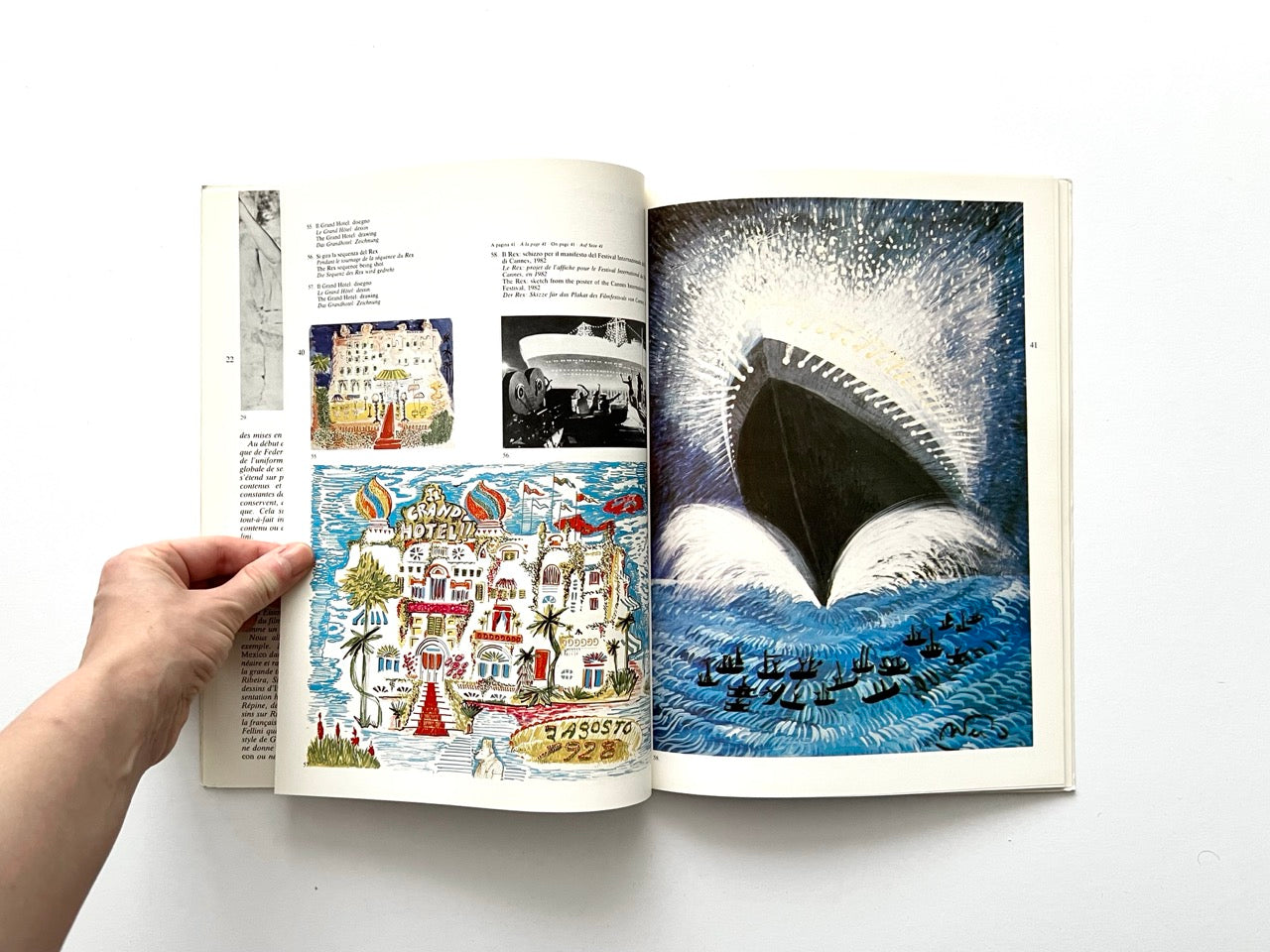 Interior spread showing two coloured drawings of the Grand Hotel on the left page, along with a small black-and-white film still. Right page features a large coloured painting of a ship’s bow cutting through waves, with dramatic white spray and deep blue water.