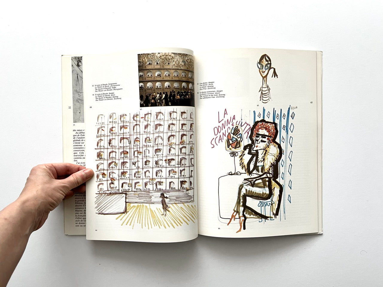 Interior spread with a detailed drawing of a theatre facade filled with small box seats on the left page, beneath a colour photograph of an ornate interior. Right page shows two character sketches: a small stylised head at the top and a coloured caricature of a seated woman labelled ‘La Donna Scancellata’