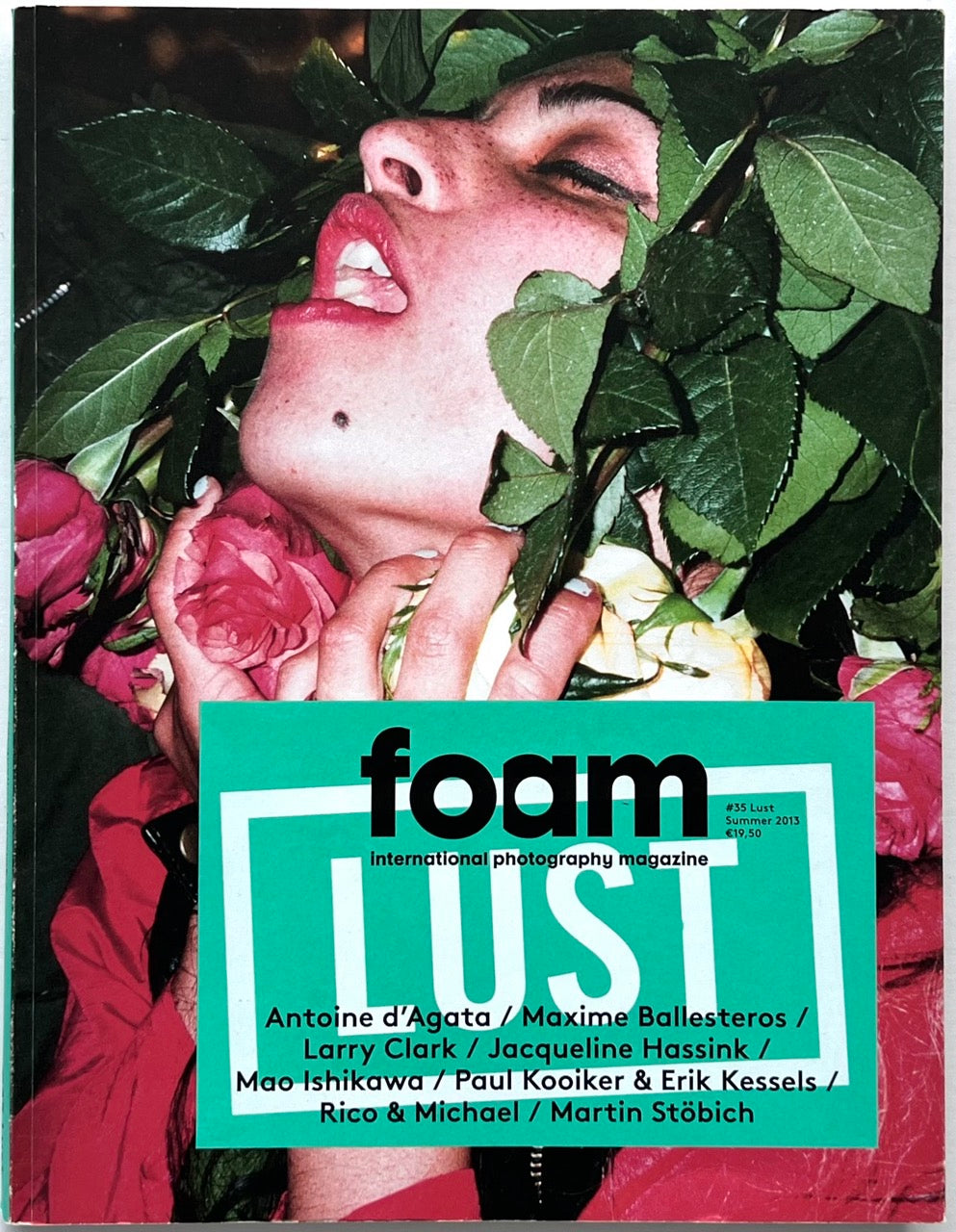 FOAM International Photography Magazine, Issue #35: Lust, Summer 2013. Front cover featuring a provocative close-up portrait of a woman surrounded by lush green foliage and pink roses, with bold turquoise typography.