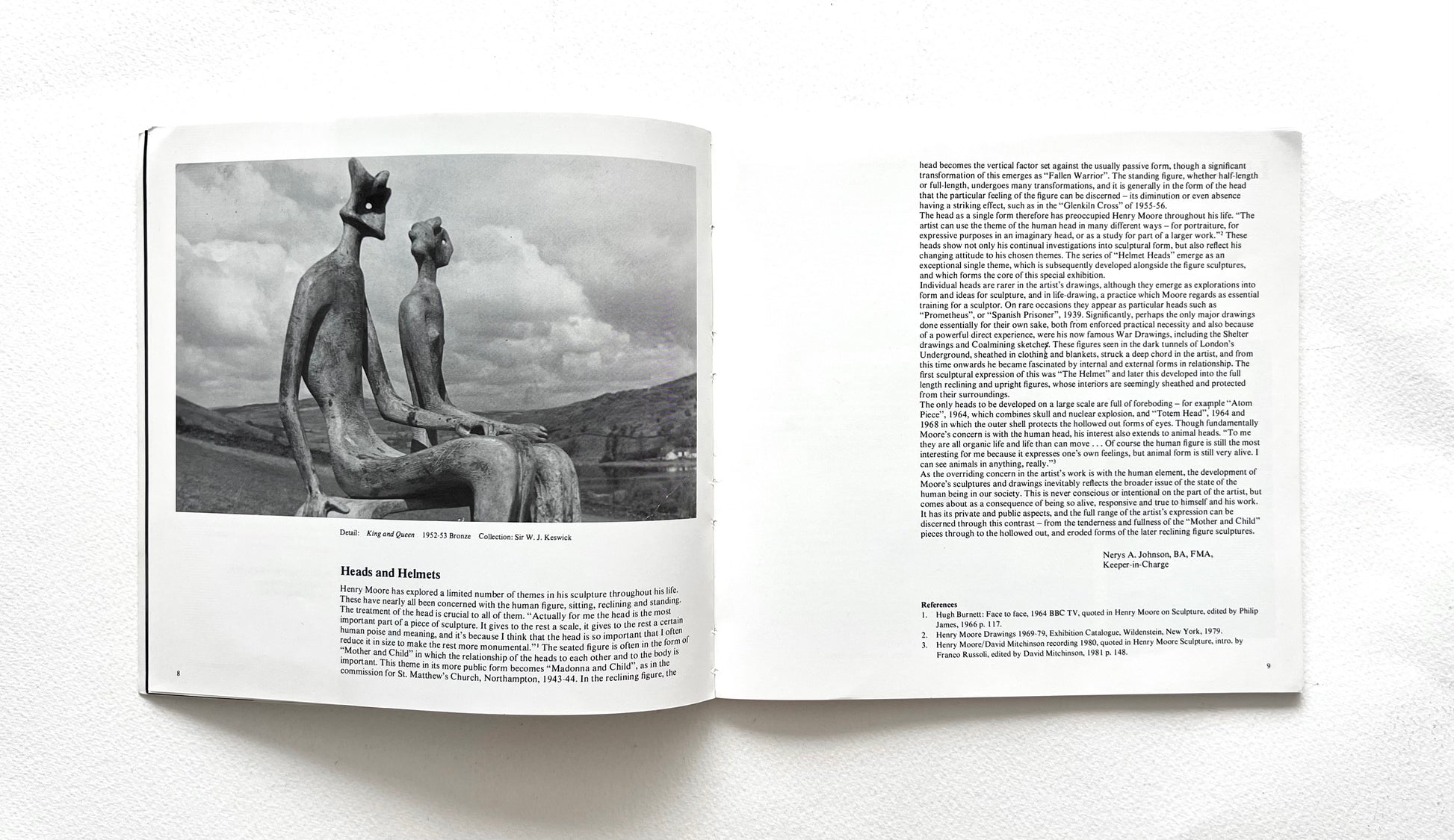Open book showing a black and white photograph of a Henry Moore's sculpture with text on a white background