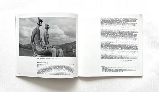 Open book showing a black and white photograph of a Henry Moore's sculpture with text on a white background