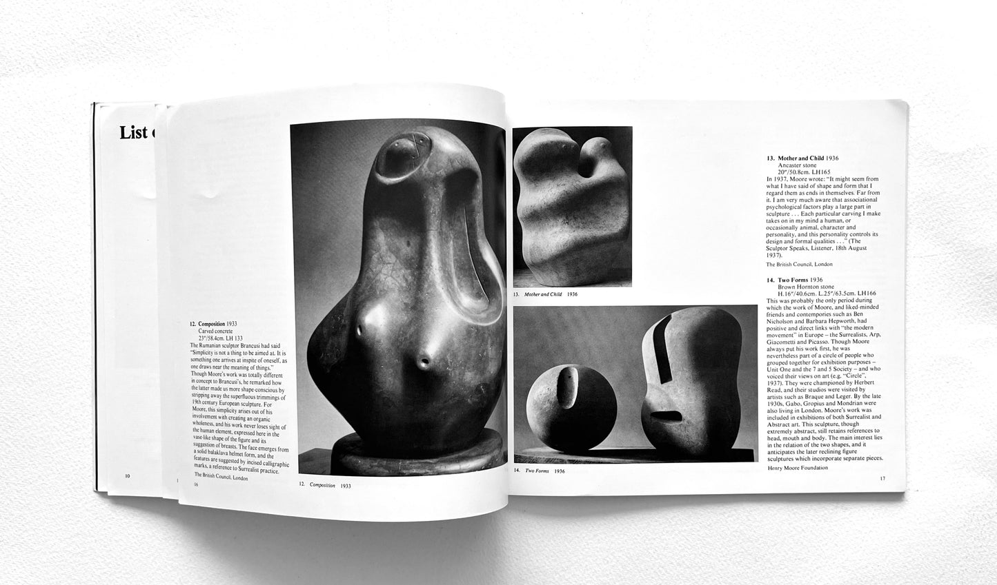 Open book displaying black and white photographs of Henry Moore's abstract sculptures on a white background