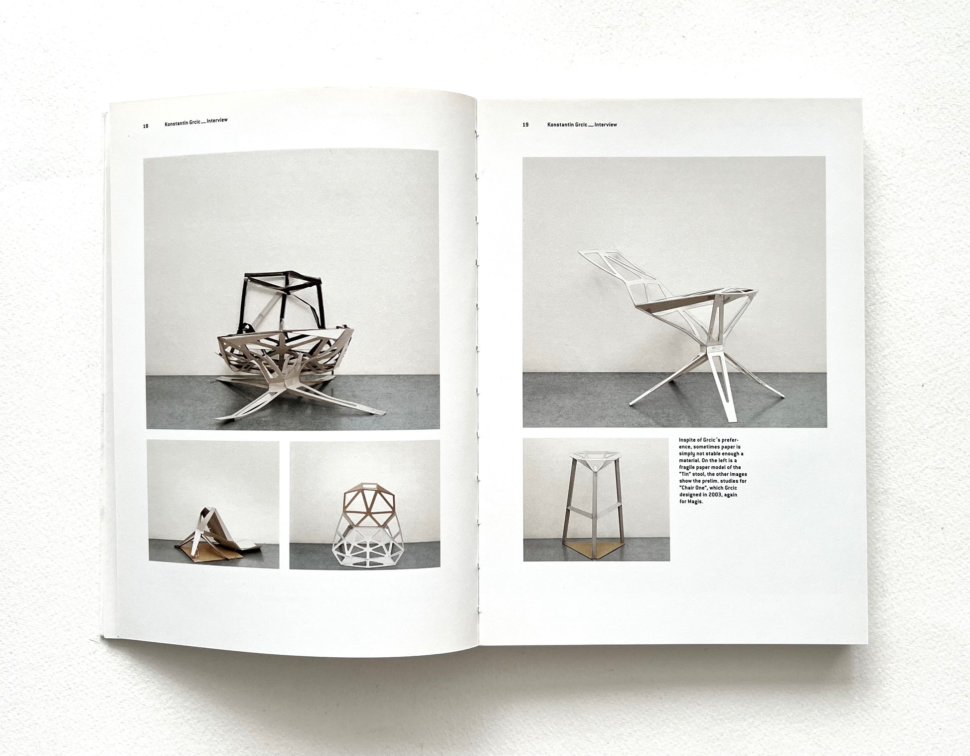 Open book showing images of geometric chairs on a white background