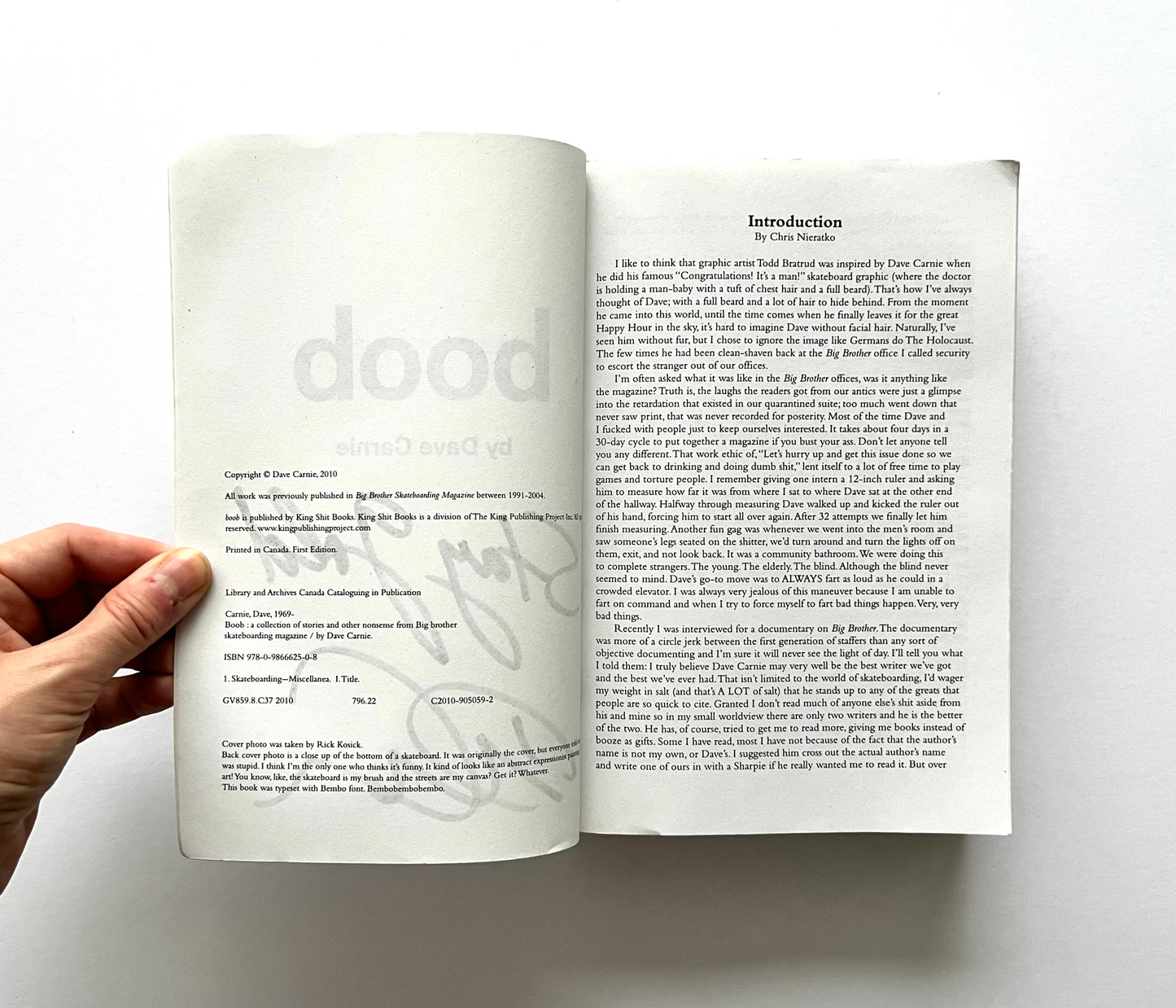 Open book showing the copyright page and the first page of the introduction to “boob” by Dave Carnie.