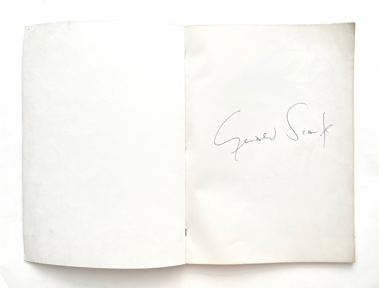 Open book 'Indecent Exposure' by Gerald Scarfe, with a signature of the author on a white background