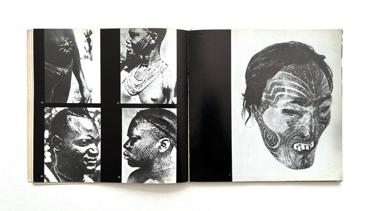 Open book showing black and white images of faces with tattoos