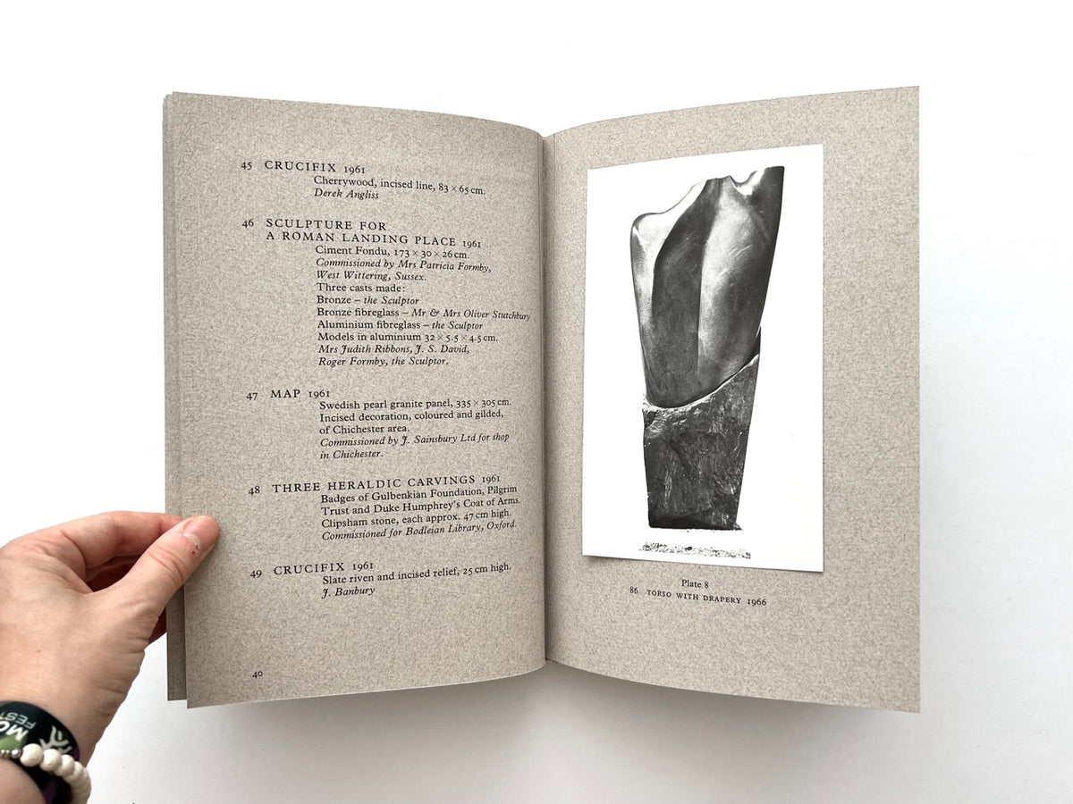 John Skelton: A Sculptor’s Work 1950–1975 (1977). Interior spread showing catalogue entries 45–49 on the left, including Crucifix, Sculpture for a Roman Landing Place, Map and Three Heraldic Carvings, with Plate 8 on the right featuring a black-and-white photograph of Torso with Drapery (1966).