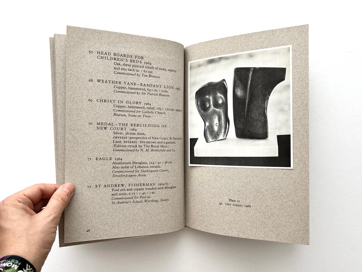 John Skelton: A Sculptor’s Work 1950–1975 (1977). Interior spread showing catalogue entries 67–72 on the left, including Head Boards for Children’s Beds, Weather Vane – Rampant Lion, Christ in Glory, Eagle and St Andrew, Fisherman, with Plate 12 on the right featuring a black-and-white photograph of Two Torsos (1968).