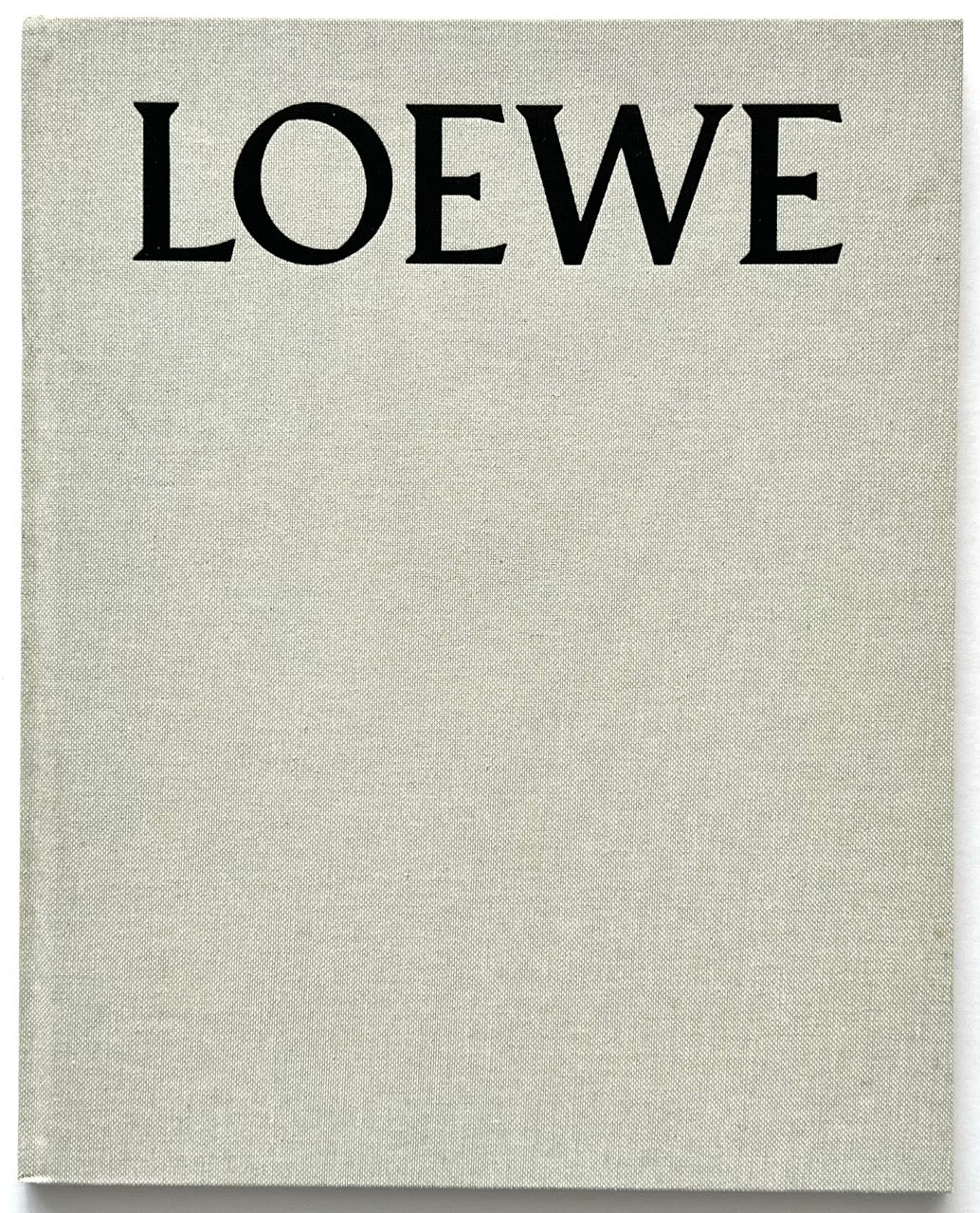 LOEWE Spring Summer 2015 Womenswear, creative direction by M/M (Paris), published 2015. Pale grey cloth hardcover with oversized black LOEWE typography.