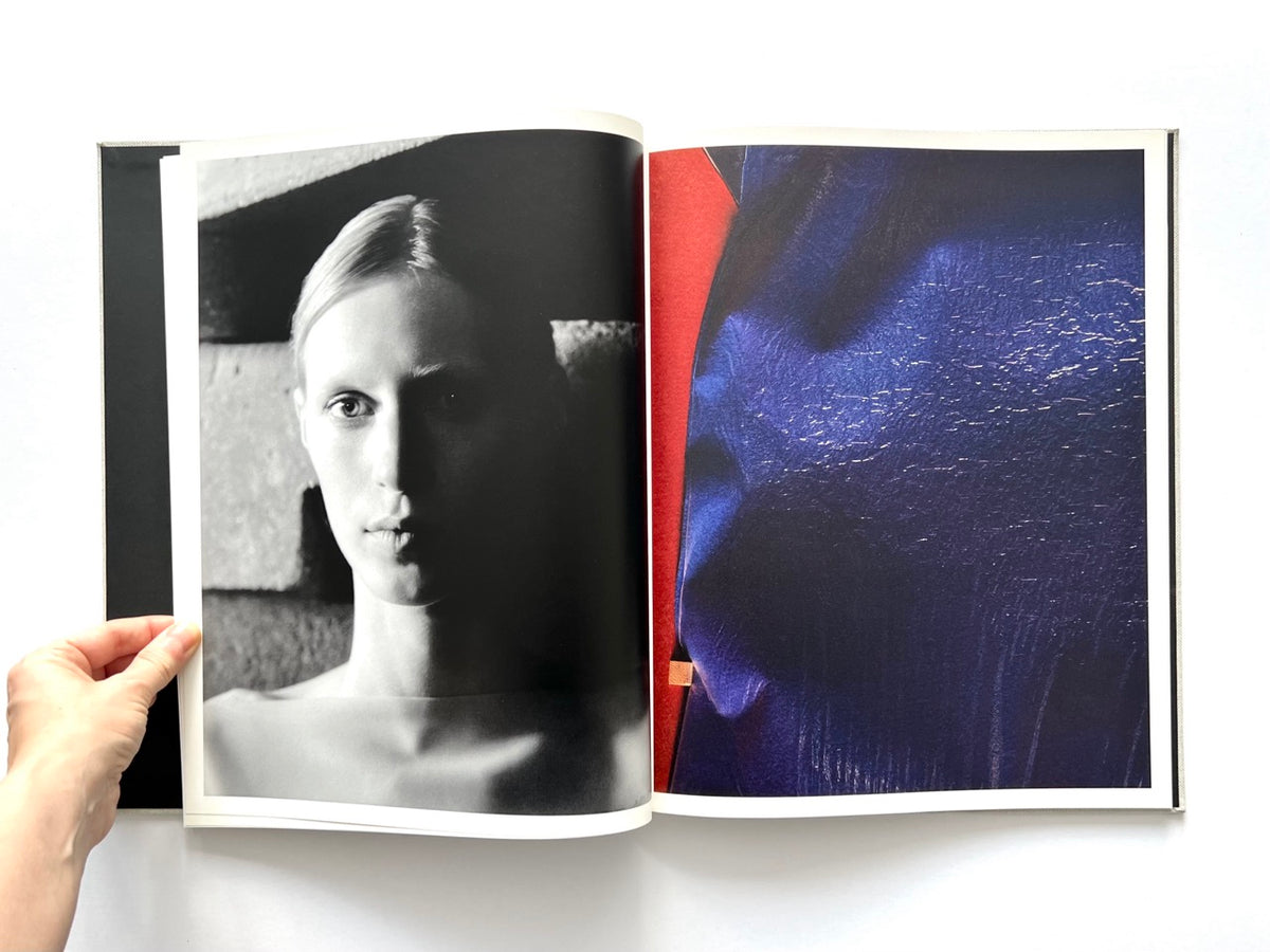 LOEWE Spring Summer 2015 Womenswear, photography by Jamie Hawkesworth, published 2015. Black-and-white portrait of Julia Nobis opposite a richly textured blue and red photograph.