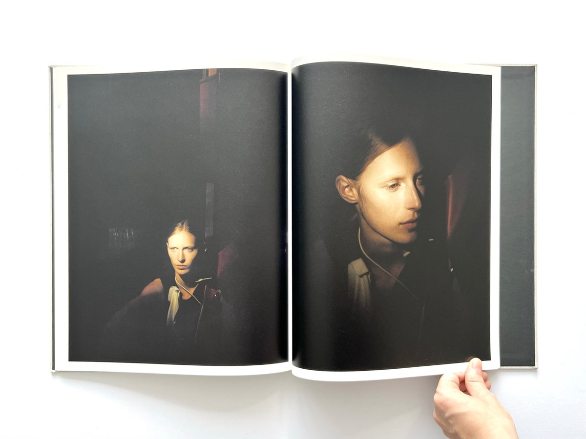 LOEWE Spring Summer 2015 Womenswear, photographed by Jamie Hawkesworth, 2015. Atmospheric double-page fashion photography spread featuring two low-light portraits of Julia Nobis, her face illuminated against a nearly black background.