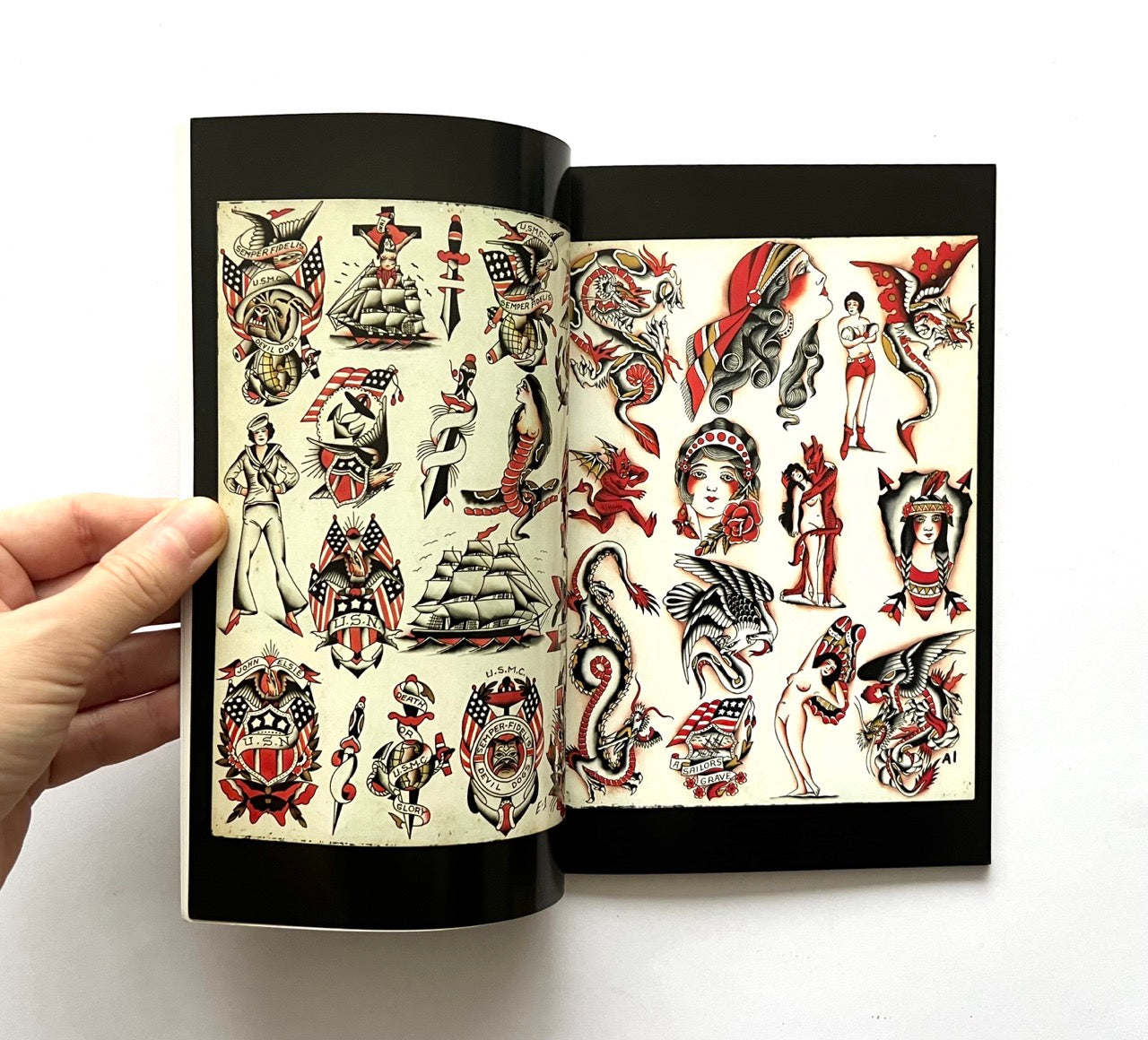 Open book - 'LOST ART: FROM TATTOOING’S PAST' - displaying vintage tattoo designs.