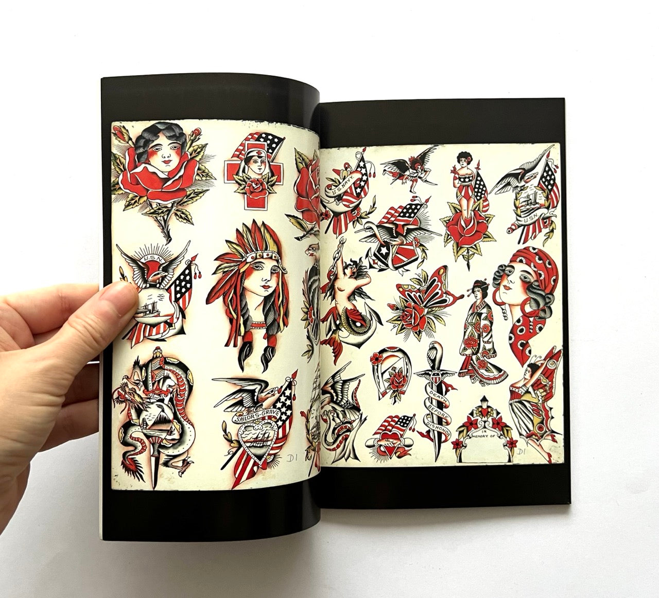 Open book - 'LOST ART: FROM TATTOOING’S PAST' - displaying traditional tattoo designs.
