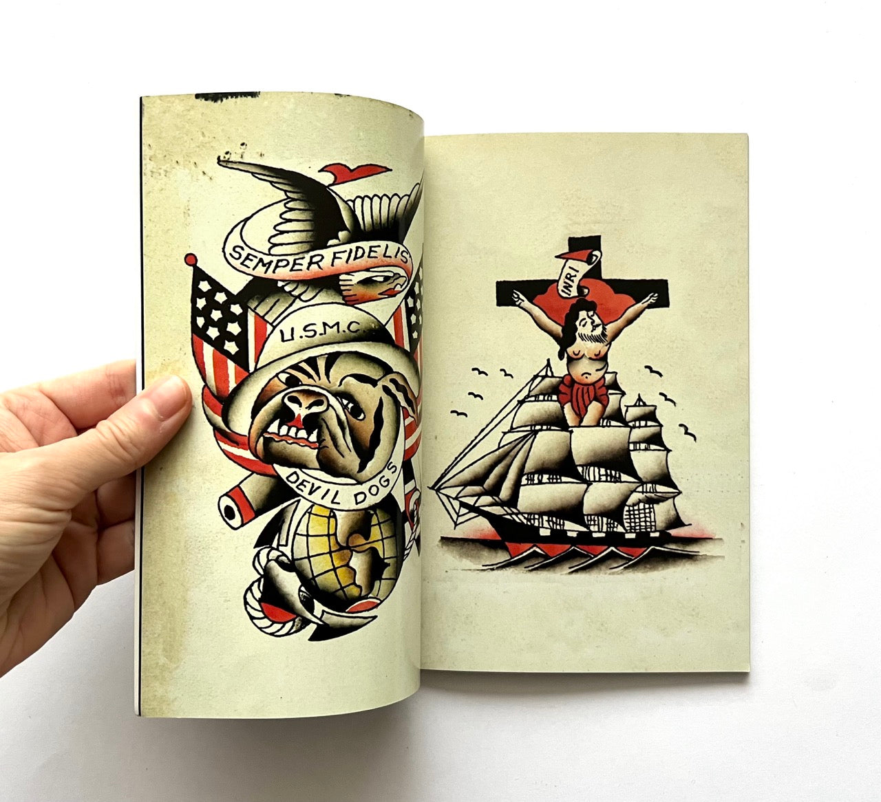 Open book - 'LOST ART: FROM TATTOOING’S PAST' - displaying vintage tattoo designs.
