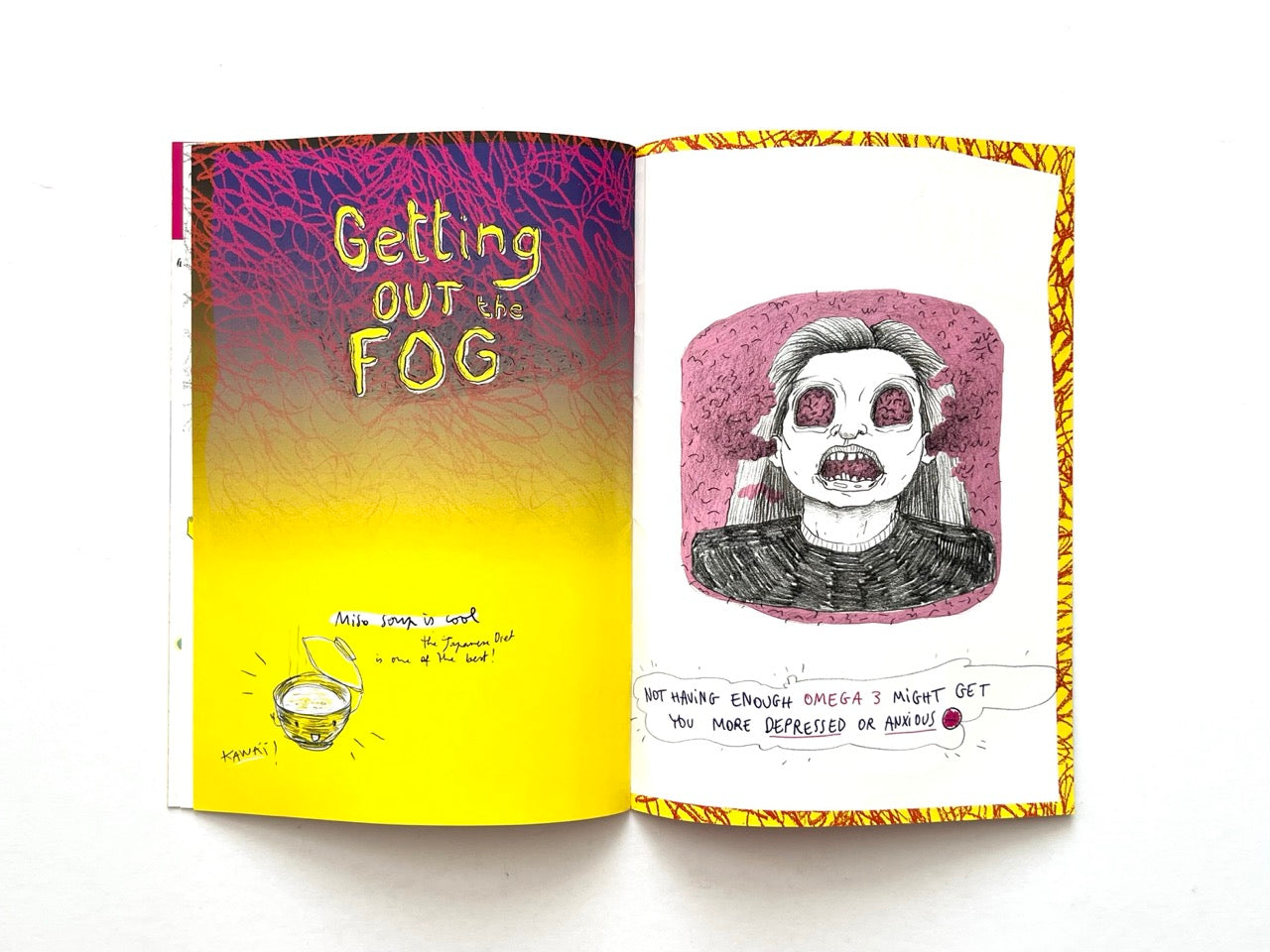 Mind Ur Food by Ayam Tulum (2017) — Pages headed “Getting Out the Fog”, featuring a surreal portrait with purple cloud-like hair and a handwritten note connecting omega-3 intake with depression and anxiety, opposite an illustrated bowl of food.