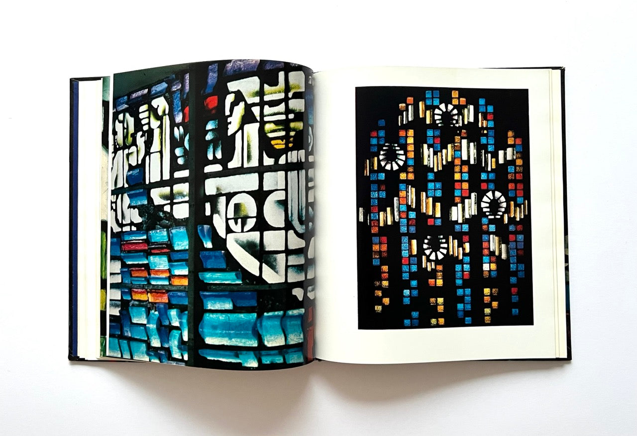 Open book - 'Moderne litauische Glasmalerei' - displaying colorful abstract stained glass designs.