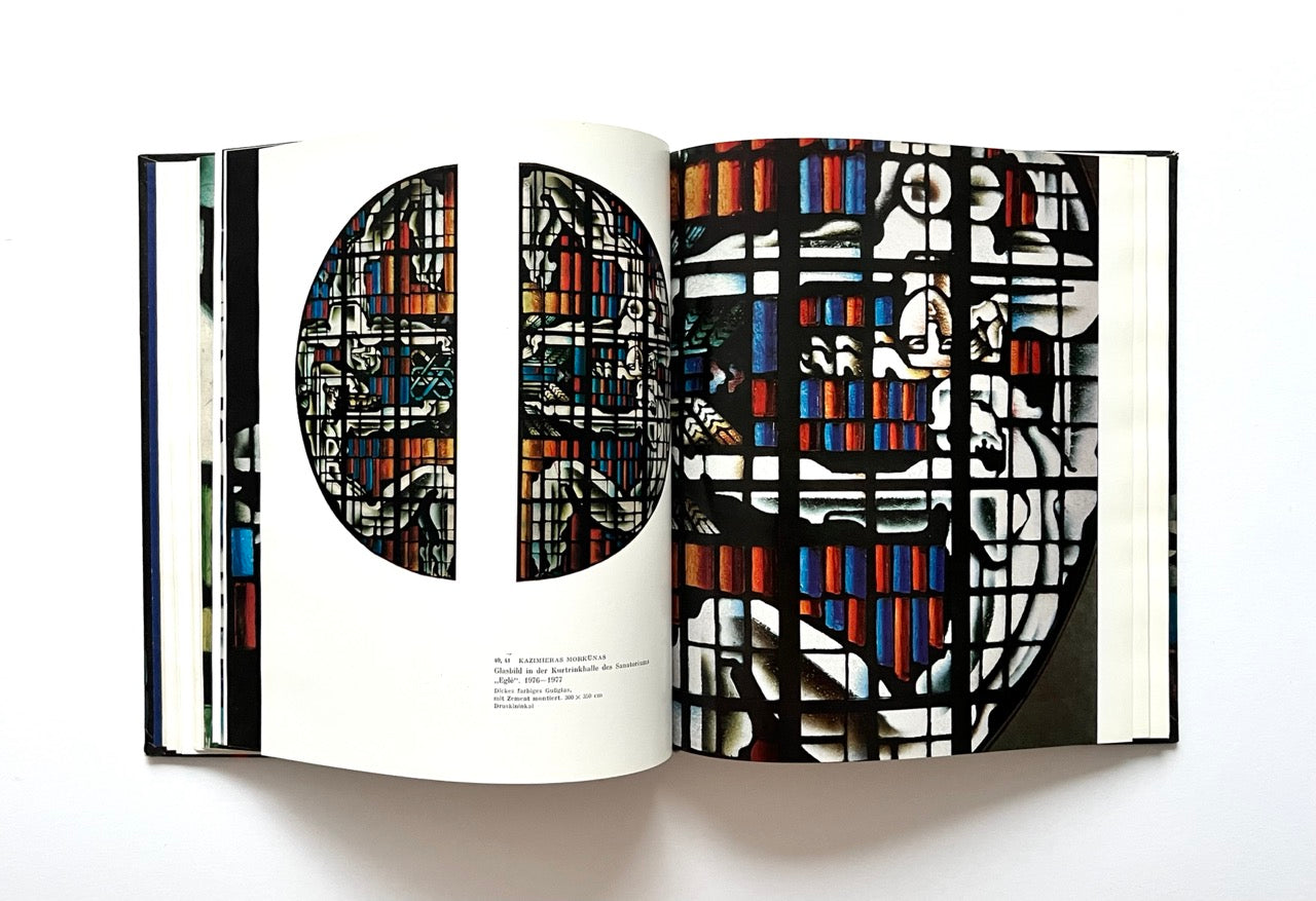 Open book displaying abstract stained glass design with geometric patterns