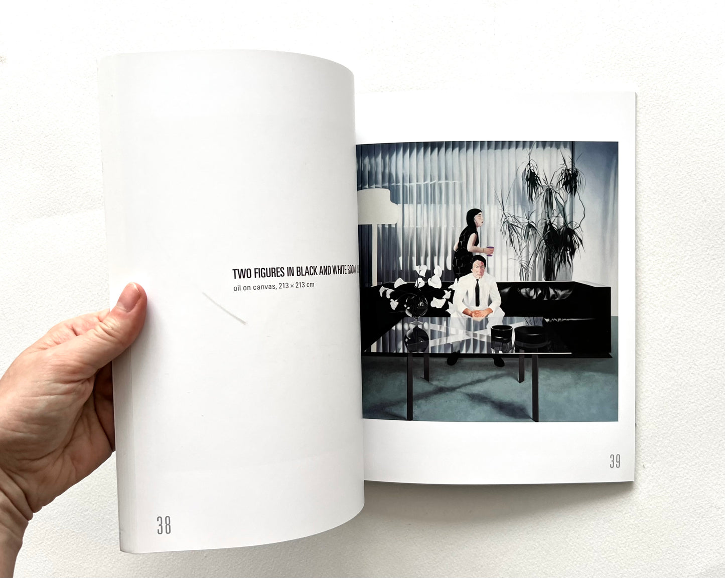 Open 'Neil Stokoe: Paintings from the 60s on' book showing an artwork of two figures in minimally furnished living room.