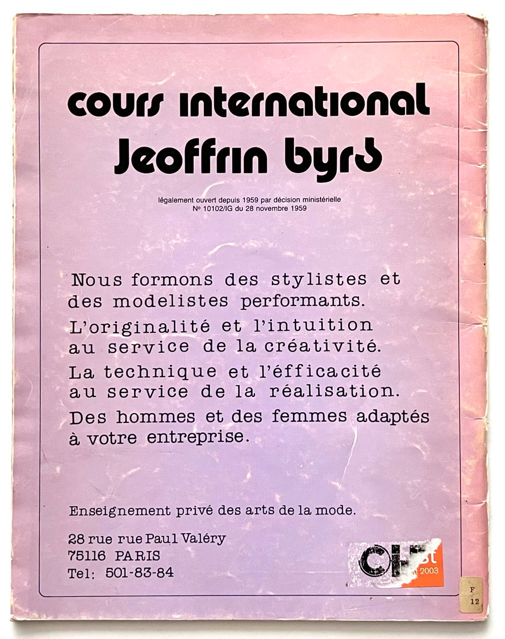 Back cover of Paris Le Styliste No 15 Spring–Summer 1985: purple gradient background with black French text promoting Cours International Jeoffrin Byrd fashion school; address and phone number printed at bottom; small torn sticker in lower right corner.