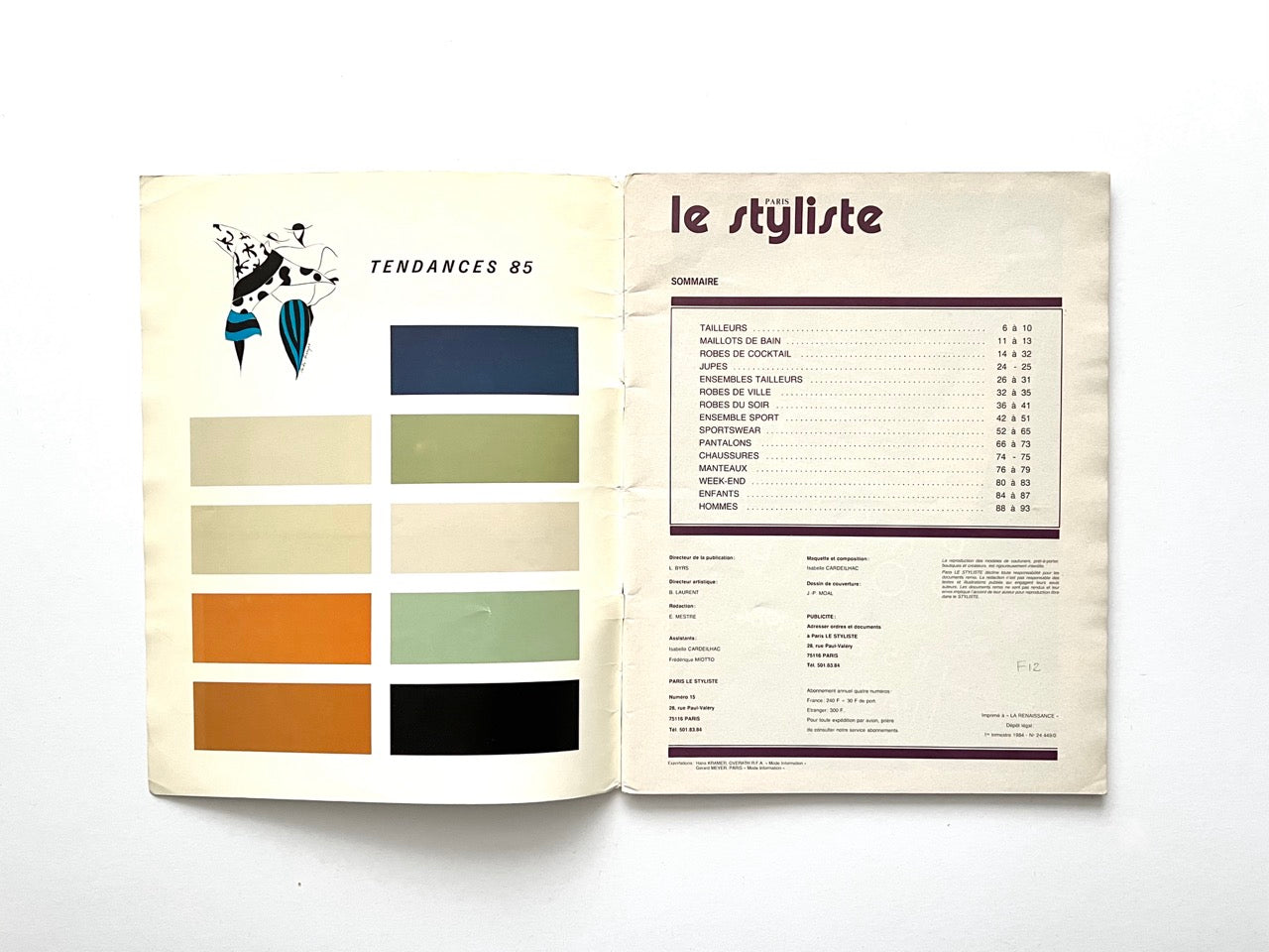Interior spread from Paris Le Styliste No. 15 (1985): left page shows nine horizontal colour blocks labelled ‘Tendances 85’ with a small fashion illustration above; right page lists the issue’s contents in French with section page numbers, printed in purple on cream paper.