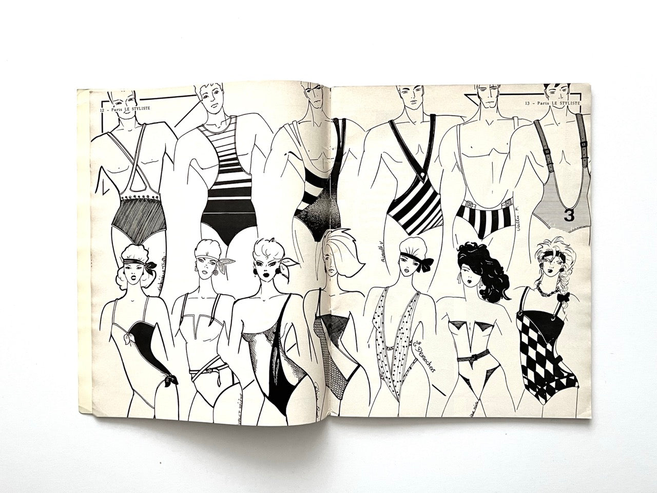 Two-page spread of 1980s swimwear illustrations from Paris Le Styliste No. 15 featuring men’s and women’s graphic swimsuits and bodysuits with bold stripes, high-cut legs, asymmetrical straps and exaggerated hairstyles