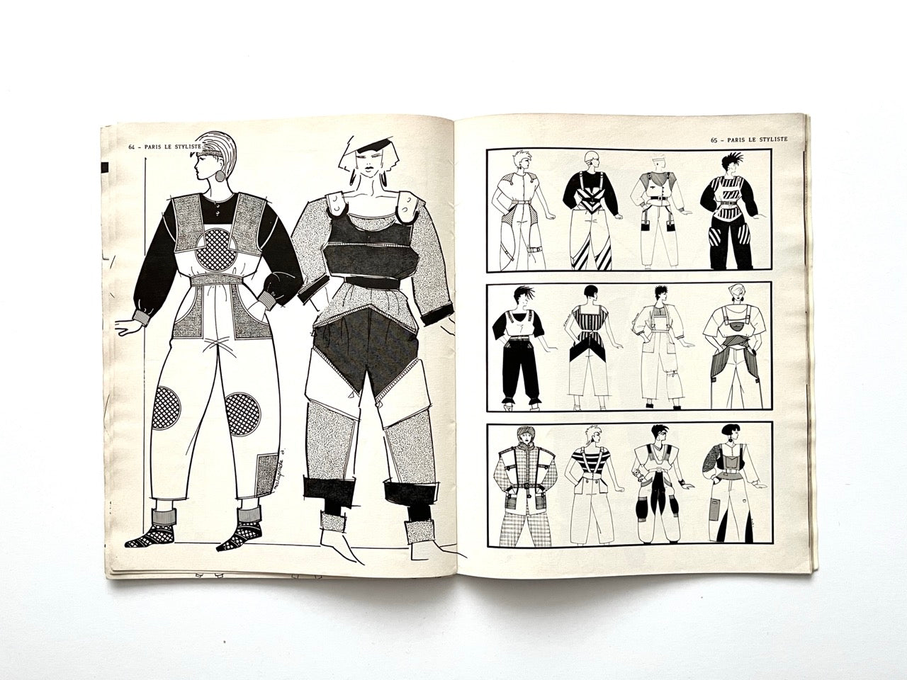Illustrated spread featuring two models in padded, modular 1980s outfits with circular knee and chest patches; right page shows three rows of coordinated looks with bold stripes, harness-style panels and exaggerated volumes.
