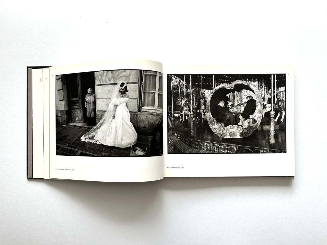 Interior spread from Parisians by Peter Turnley, published in 2000, featuring black-and-white photographs of a bride outside a church and people riding a carousel in Paris.