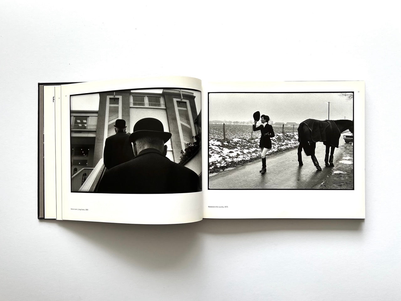 Interior spread from Parisians by Peter Turnley, published in 2000, showing black-and-white photographs of men in bowler hats and a woman walking a horse through a snowy rural landscape.