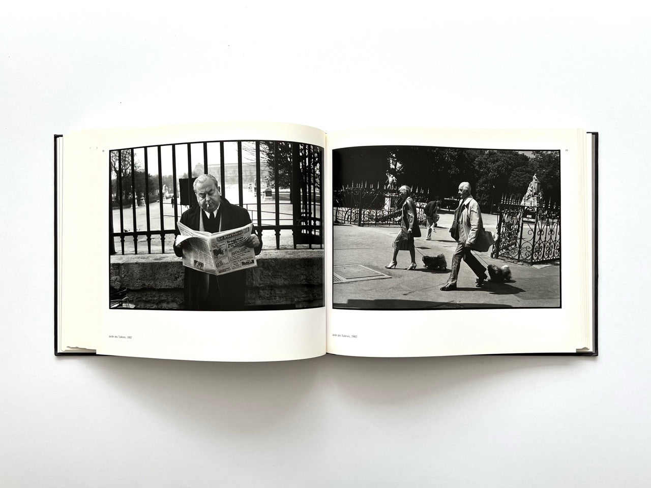 Interior spread from Parisians by Peter Turnley, published in 2000, showing black-and-white photographs of people in the Jardin des Tuileries and pedestrians walking through a Paris park.