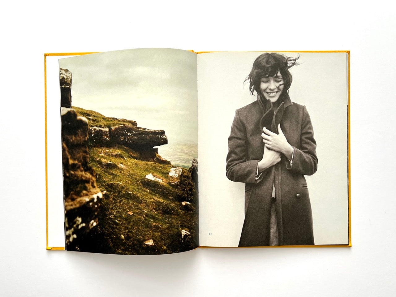 Interior spread from Sessùn Automne Hiver 2015 / 2016 catalogue with landscape photograph and black-and-white portrait of model in coat