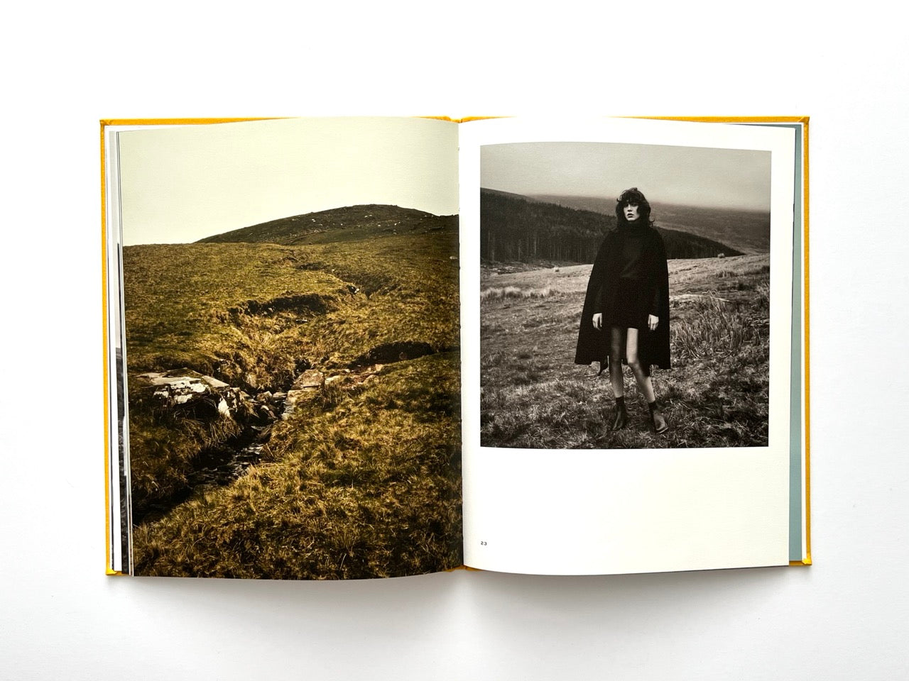 Interior spread from Sessùn Automne Hiver 2015 / 2016 catalogue with landscape photograph and black-and-white fashion portrait outdoors