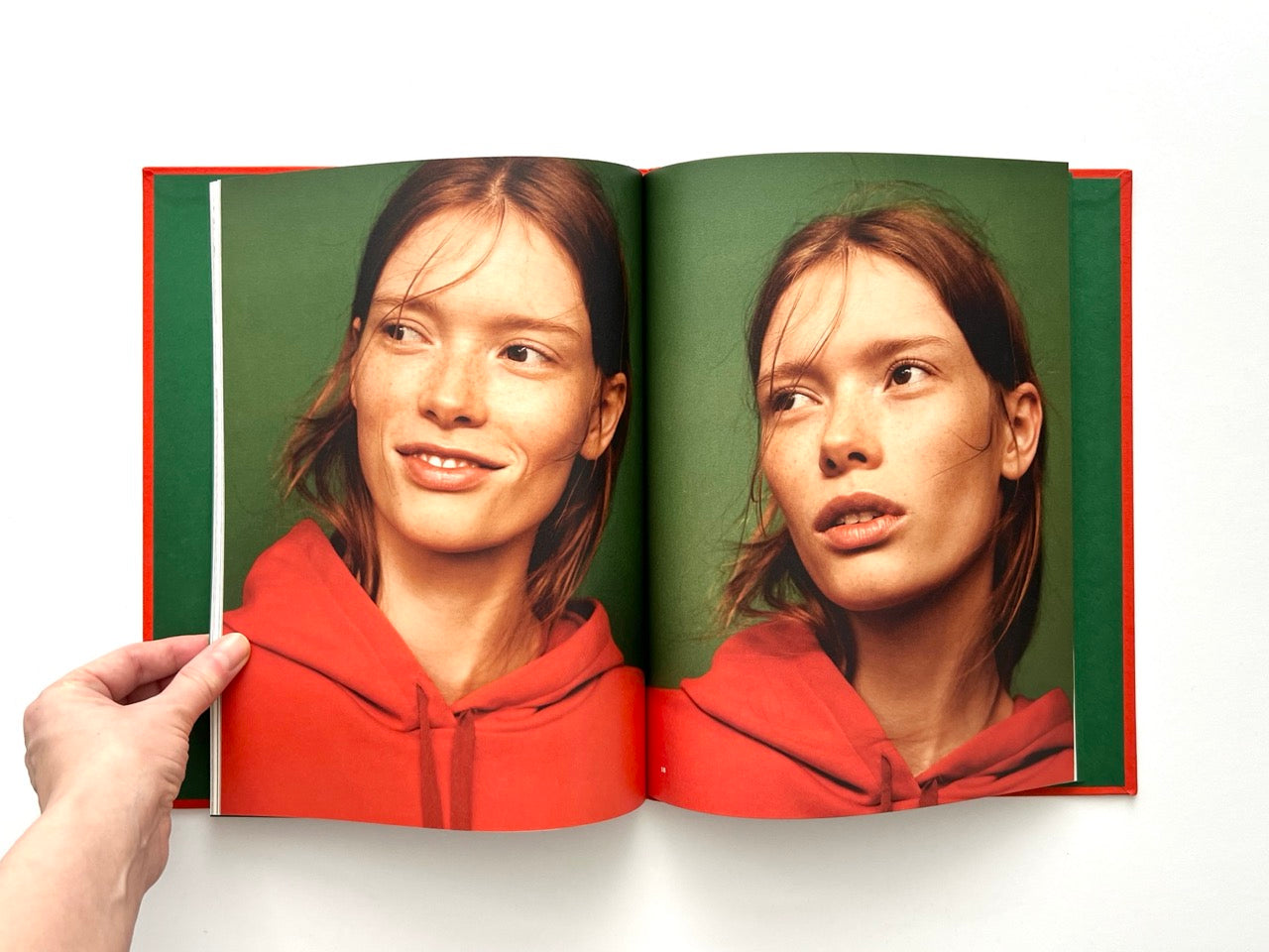 Interior spread from Sessùn Automne-Hiver 16/17 catalogue showing double portrait in red hoodie against green background