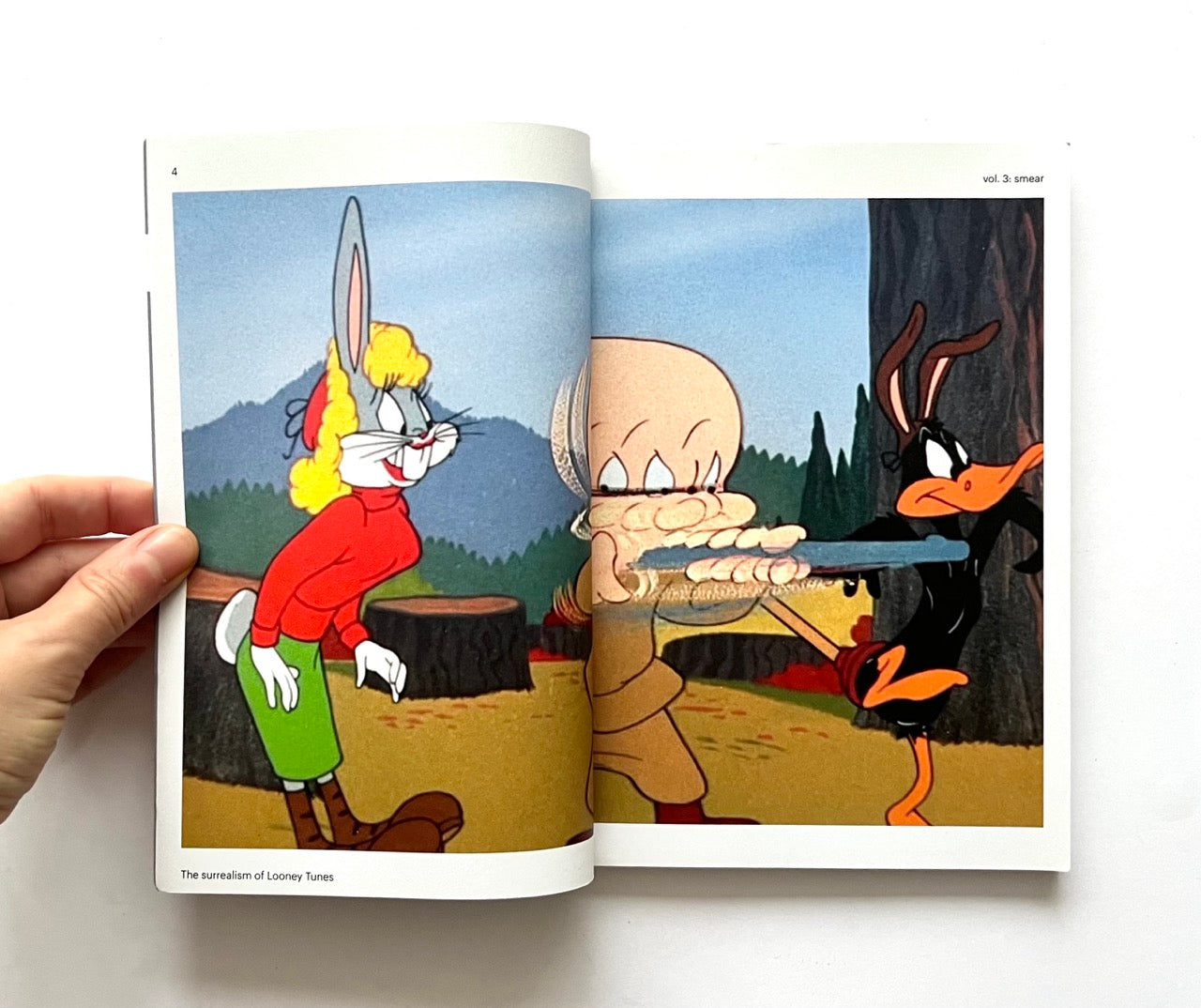 'Smear: the surrealism of Looney Tunes vol. 3' book open to a page with cartoon characters in a forest setting