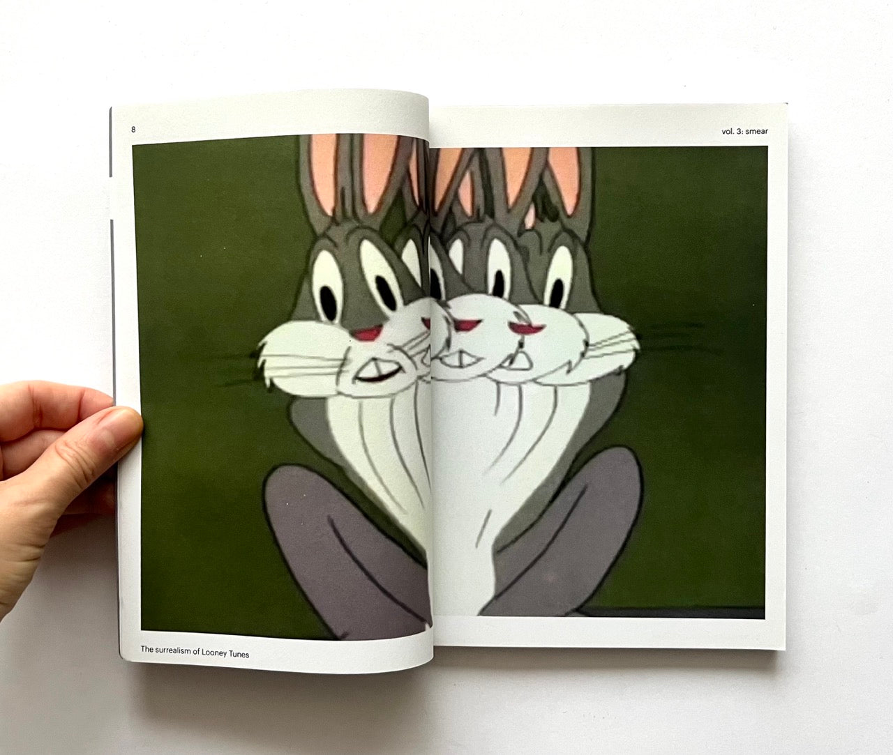 Open book - 'Smear: the surrealism of Looney Tunes vol. 3' - showing cartoon character Bugs Bunny on a green background
