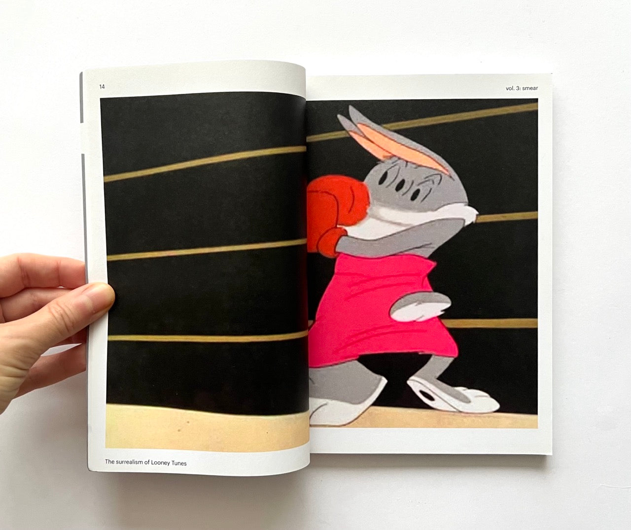 Open book - 'Smear: the surrealism of Looney Tunes vol. 3' - showing Bugs bunny on a boxing ring.