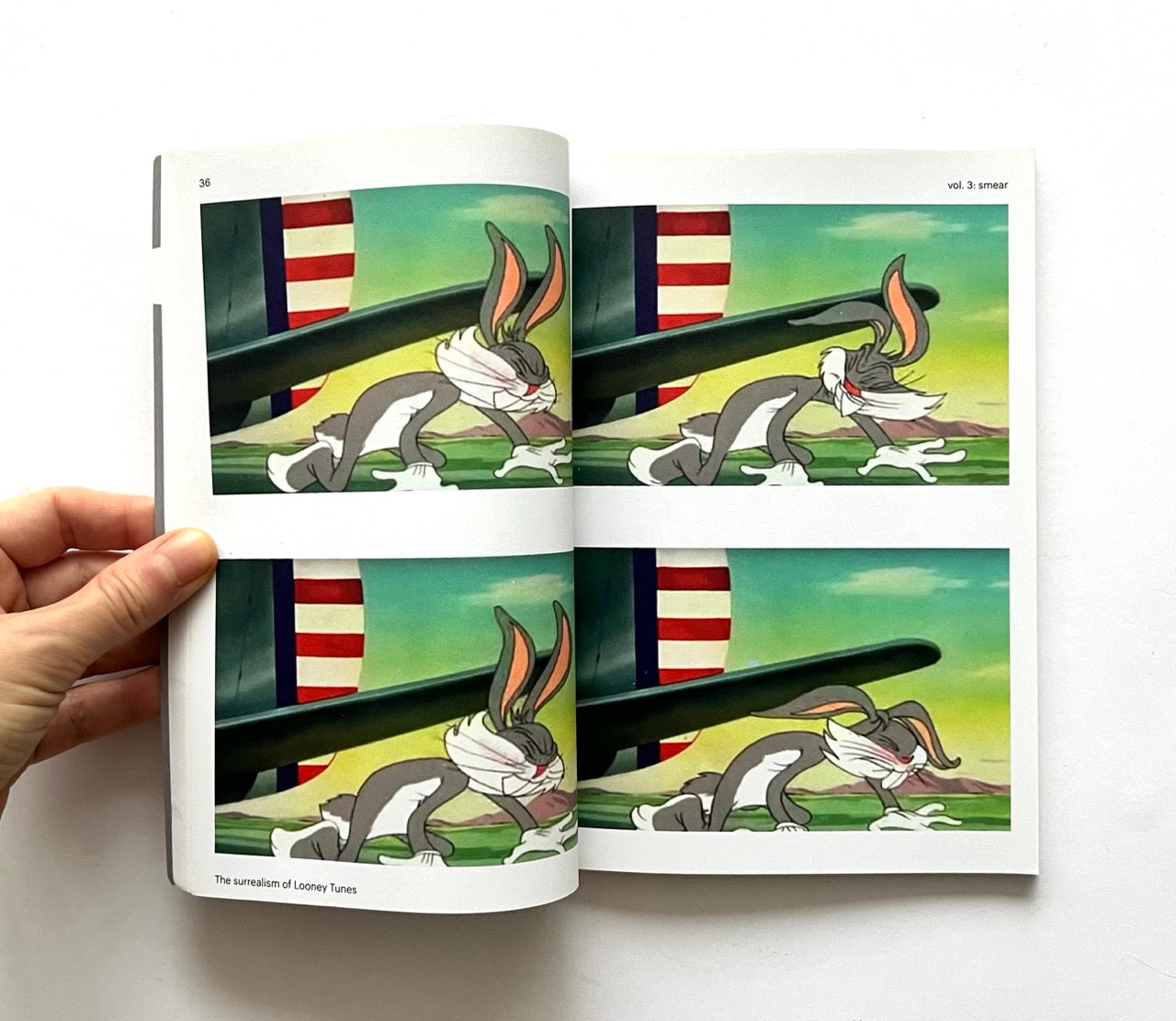 Open book - 'Smear: the surrealism of Looney Tunes vol. 3' - showing Bugs Bunny in a dynamic pose.