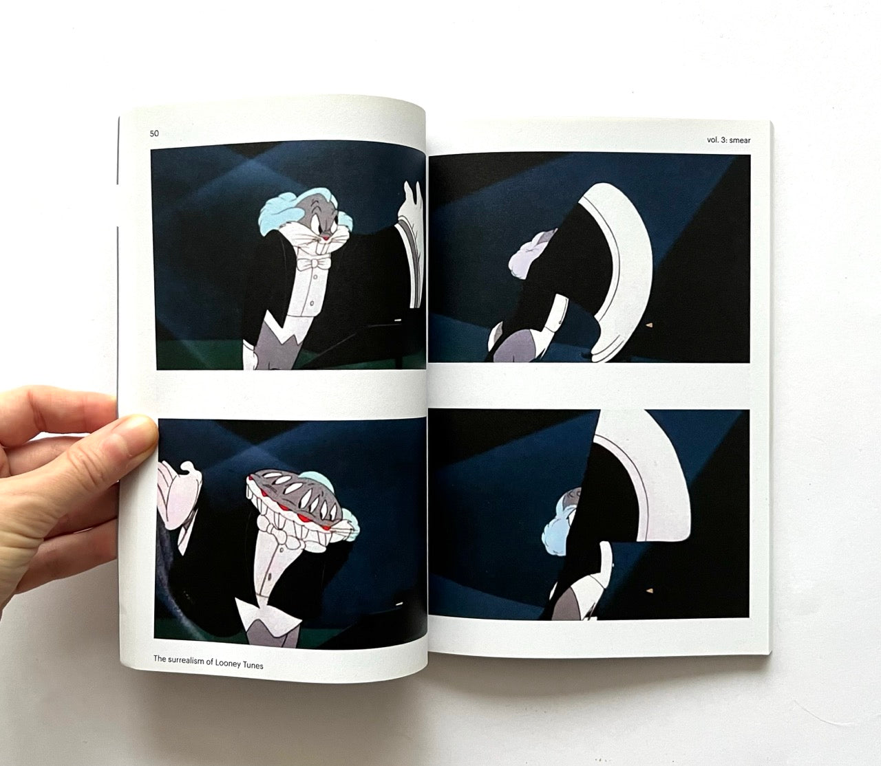 Open book - 'Smear: the surrealism of Looney Tunes vol. 3' - showing animated Bugs Bunny.