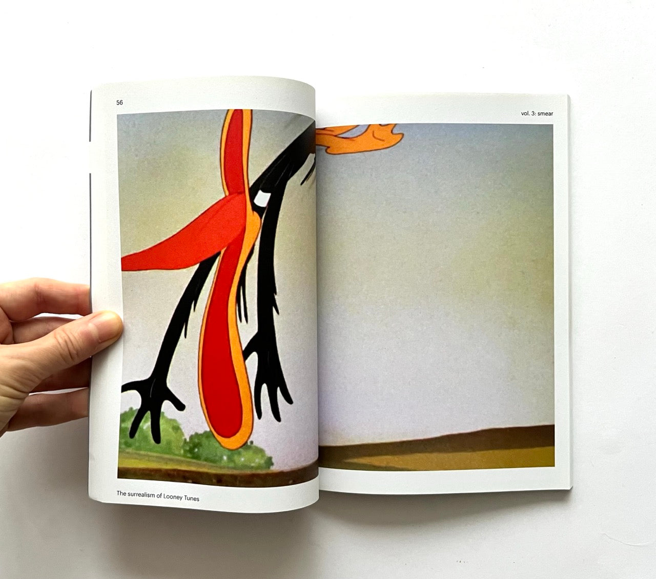 Open book showing a cartoon character.