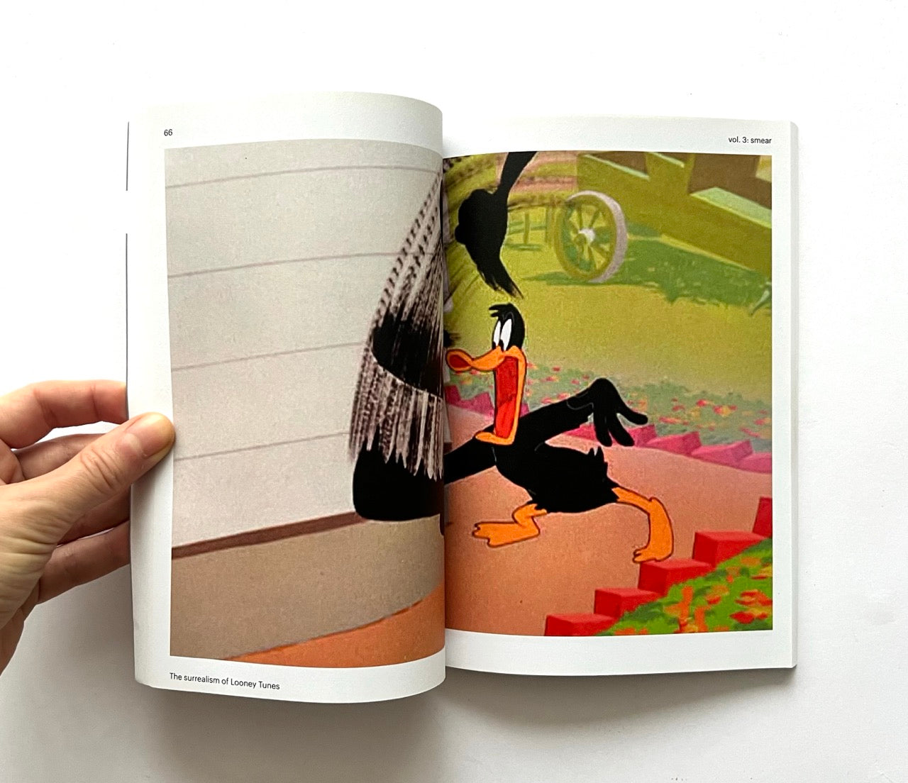 Open book showing a cartoon character in a garden setting.