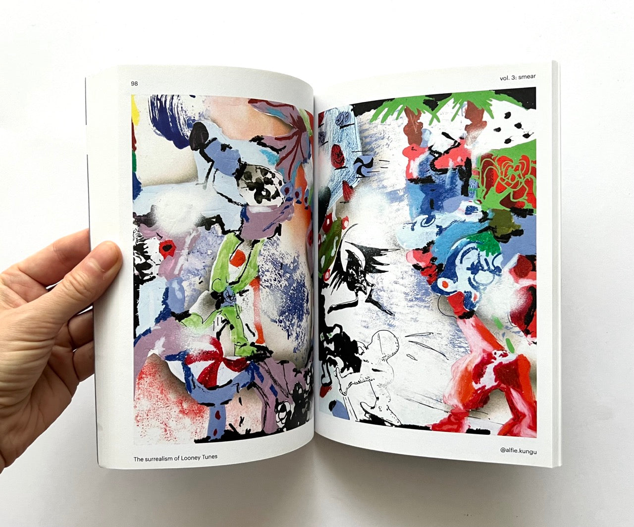 Open book - 'Smear: the surrealism of Looney Tunes vol. 3' - displaying abstract art.