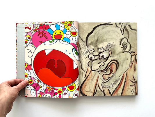 Takashi Murakami Lineage of Eccentrics spread showing a large cartoon face alongside a traditional Japanese ink drawing