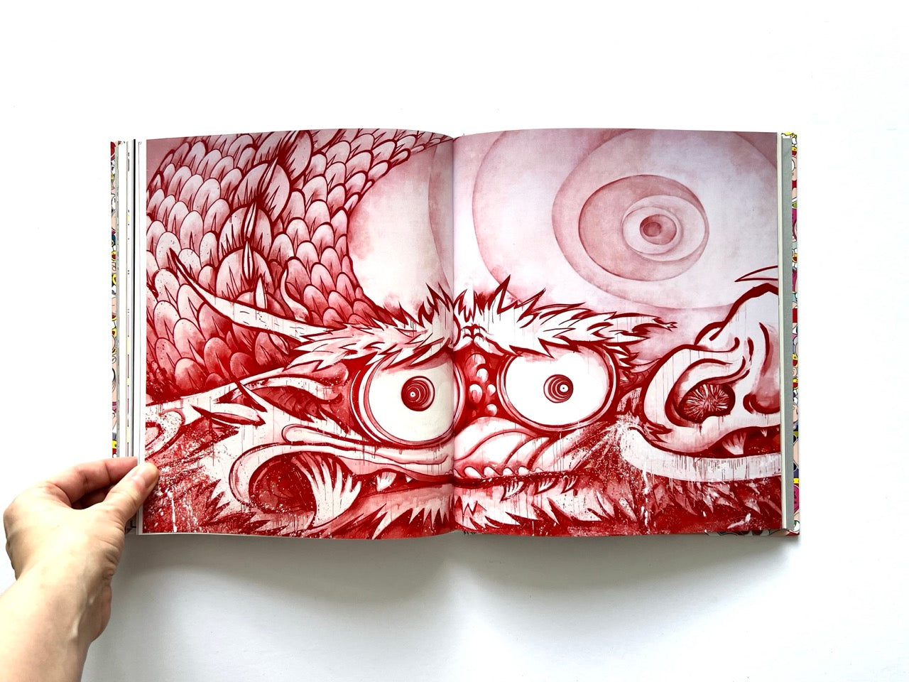 Takashi Murakami Lineage of Eccentrics interior spread showing a close-up red ink dragon face with scales and swirling background