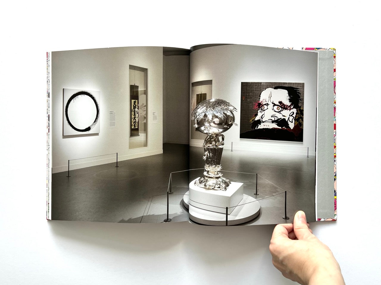 Takashi Murakami Lineage of Eccentrics interior spread showing a museum installation view with contemporary artworks including a large portrait and sculptural piece