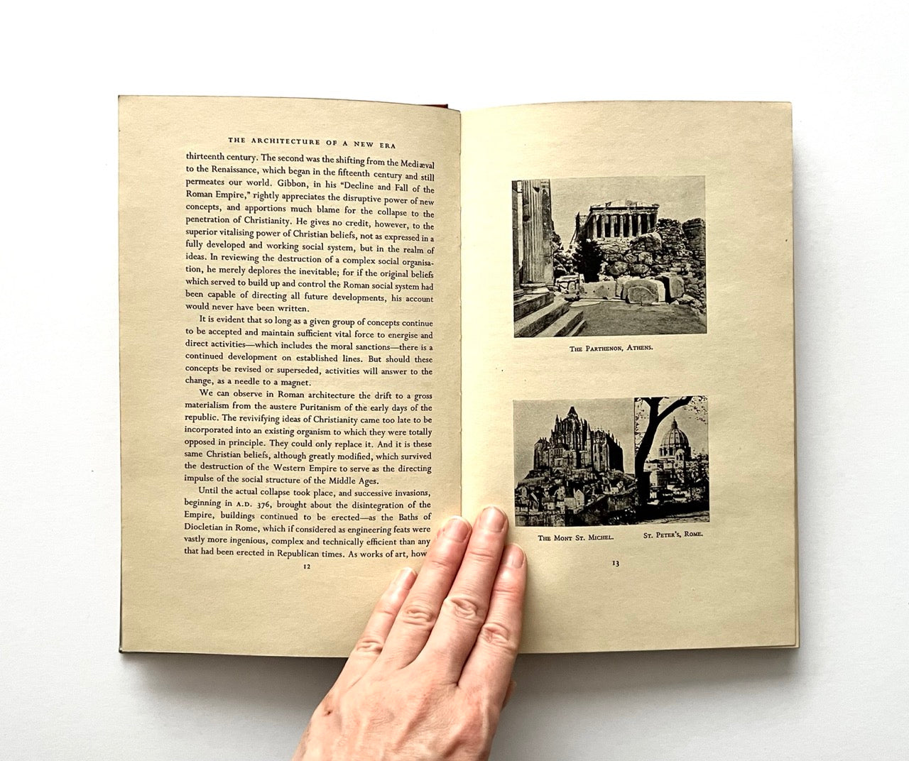 Open book - "The Architecture of a New Era' - with text and black and white images on a white background