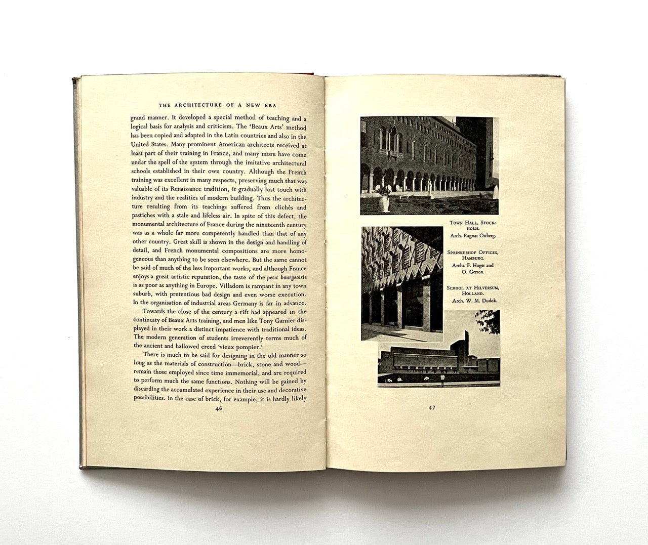 Open book - "The Architecture of a New Era' - with text and black and white architectural photographs on a white background